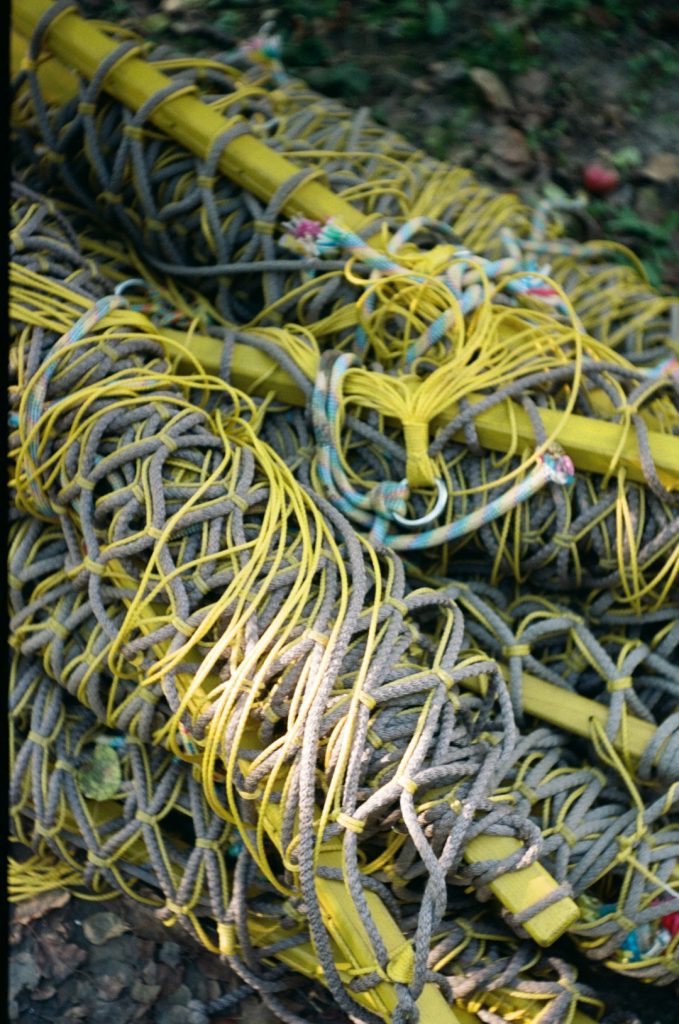 a-pile-of-yellow-and-gray-ropes-on-the-ground-7gonn5vz5-u